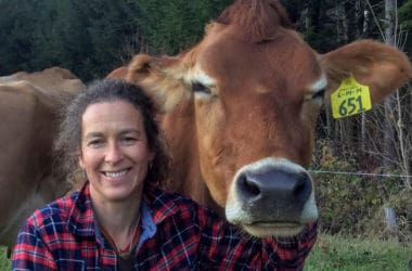 Amy Richardson posing with brown cow