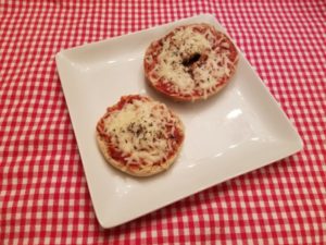 Two bagel cheese pizzas on a plate