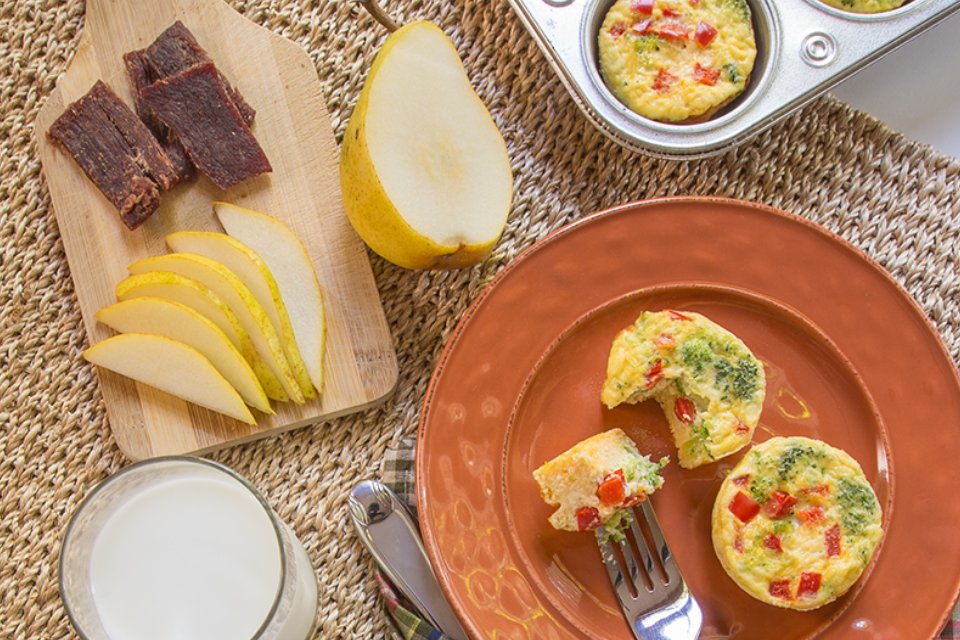 Broccoli frittatas on place with fruit