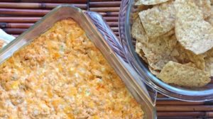 Bowl of chips with finished buffalo chicken dip for Sunday's big game