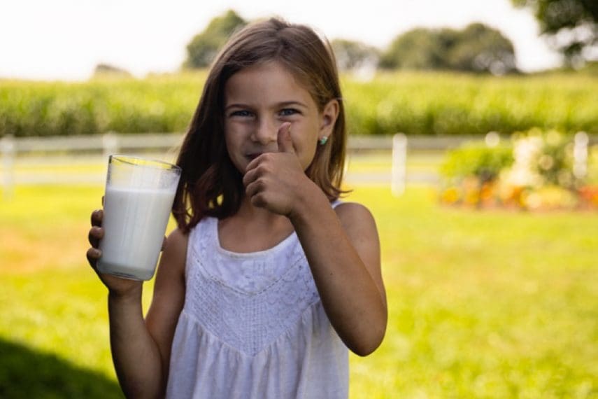 young girl with glass of milk