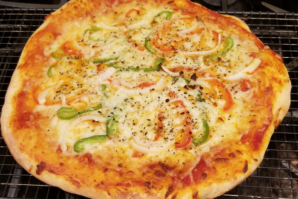 Full round pizza with cheese and peppers