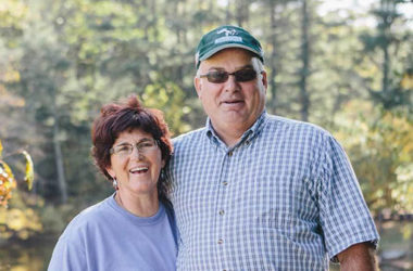 Owners Mark and Tammy posing in front of pasture