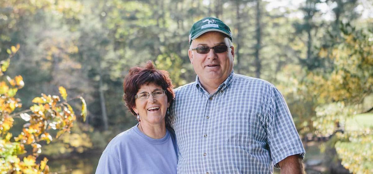 Owners Mark and Tammy posing in front of pasture