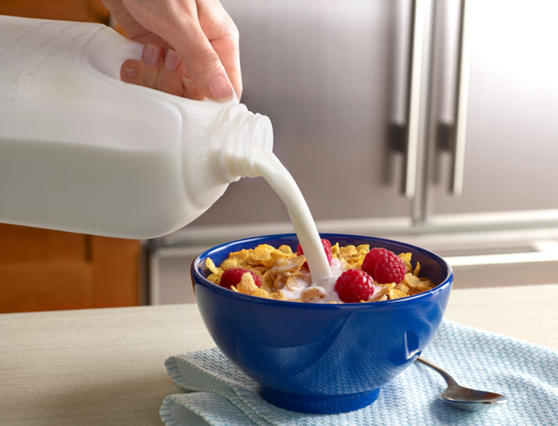 milk being poured into cereal