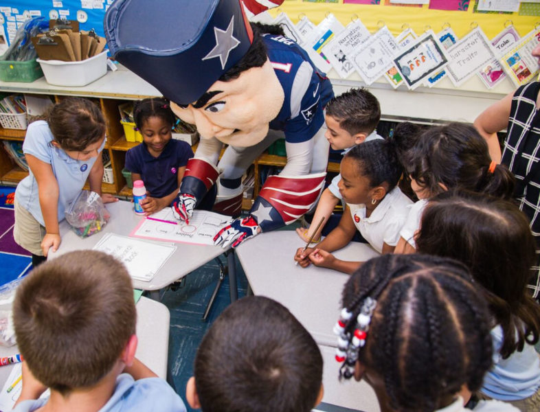 patriots mascot doing schoolwork with kids