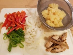 Various pizza toppings. Red and green peppers, onion, chicken and pineapple. 