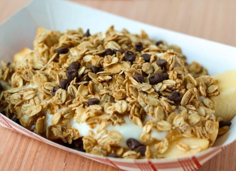 Paper boat of apple slices, yogurt, oats