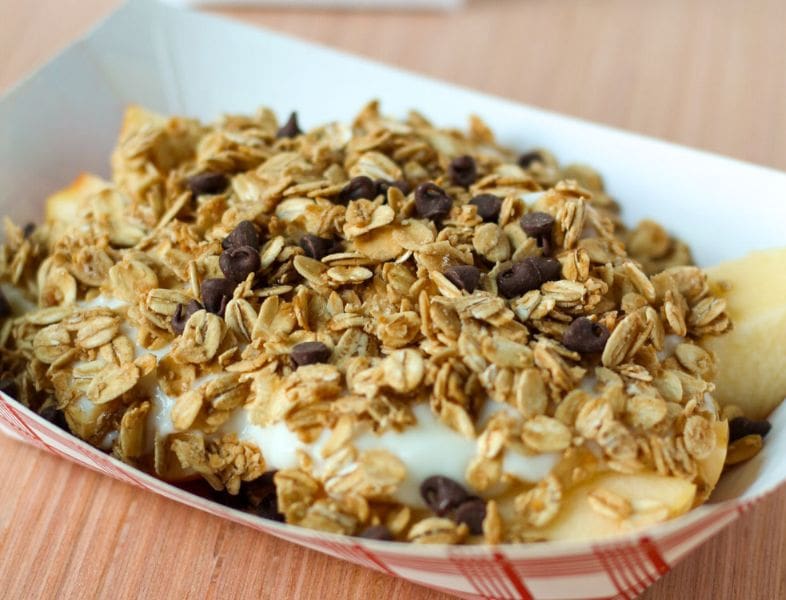 Paper boat of apple slices, yogurt, oats