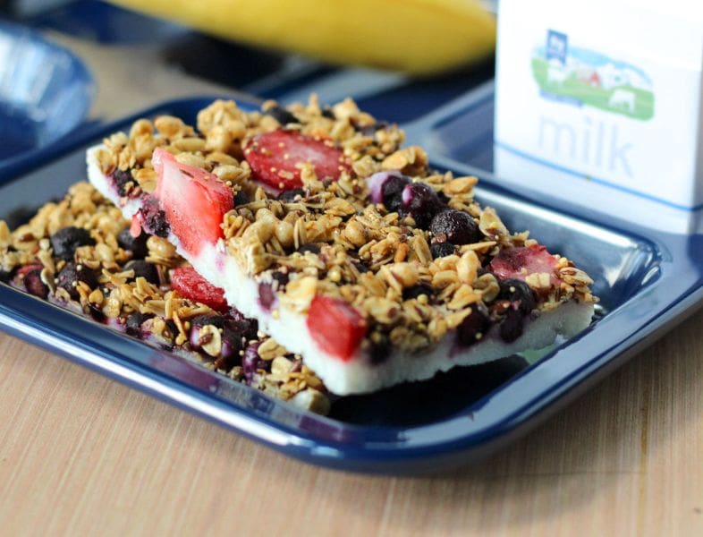 yogurt and oat bar with berries on tray with milk carton