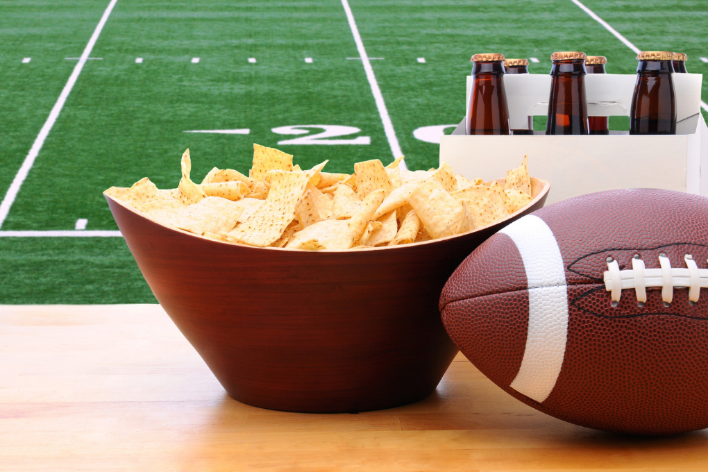 Football, chips and beer with football field in background