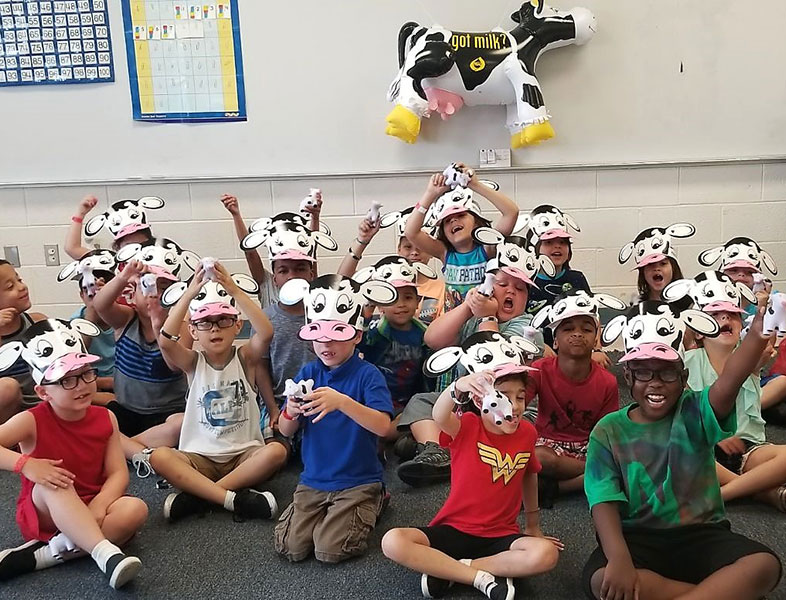 Kids with cow hats posing for camera