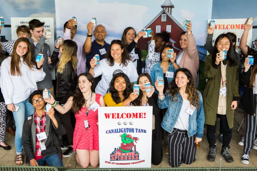group of teens holding milk