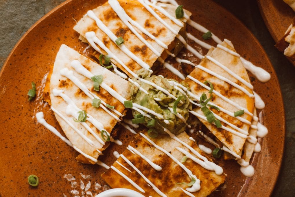 quesadilla made with leftovers drizzled with sour cream sauce