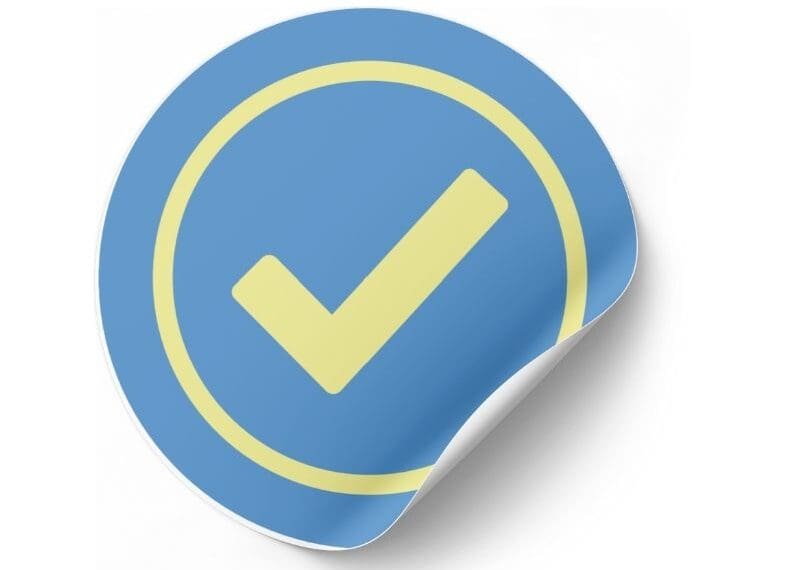 Yellow check mark on a round blue sticker mock up